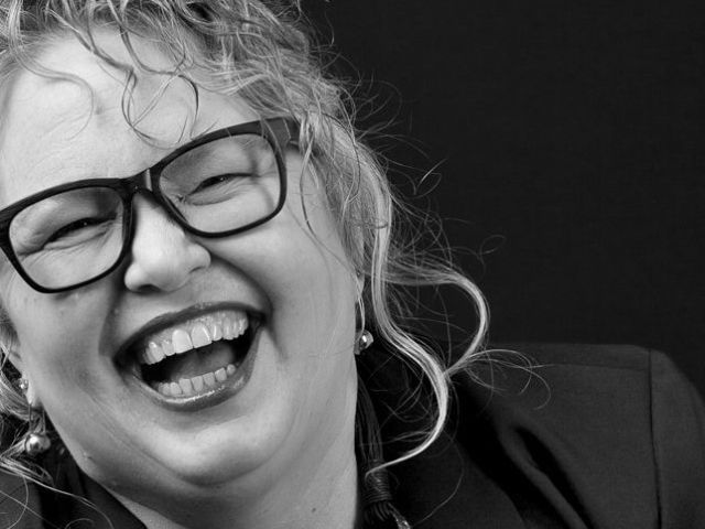 2024-Kelly-BW-laughing-w-glasses-EDIT