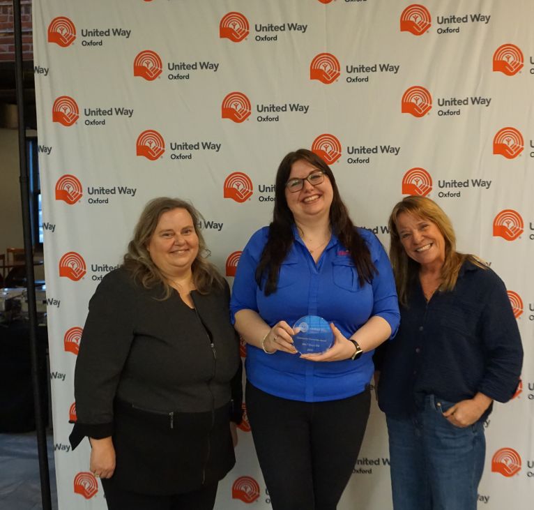 Group of employees from 104.7 Heart FM accepting their award