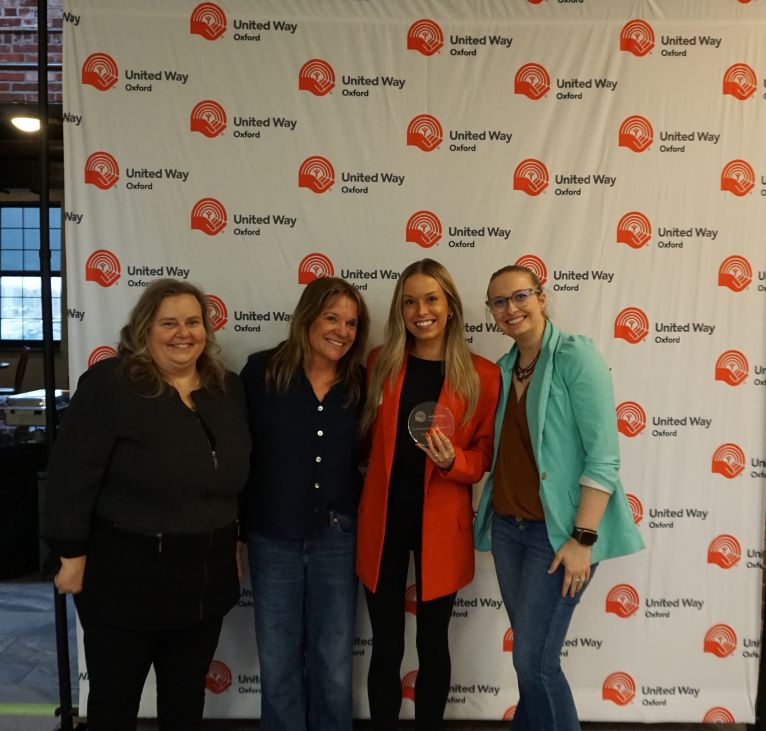 Group of employees from Pow Engineering accepting their award